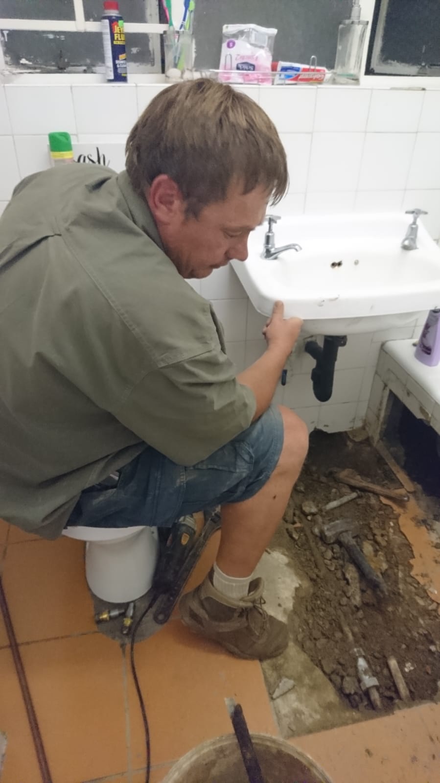 Pieter completing household basin plumbing work